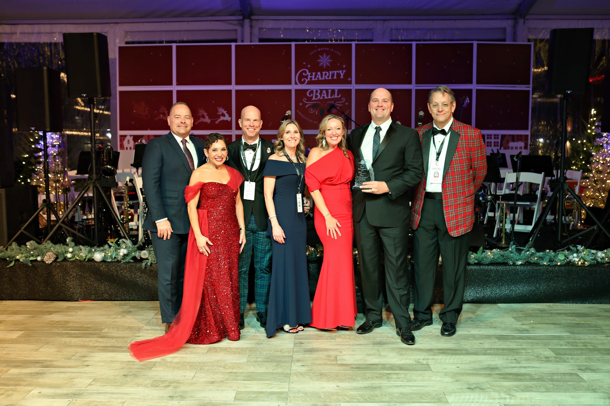 Seven WaterIsLife leaders and sponsors gathered together on stage at the 2025 Charity Ball